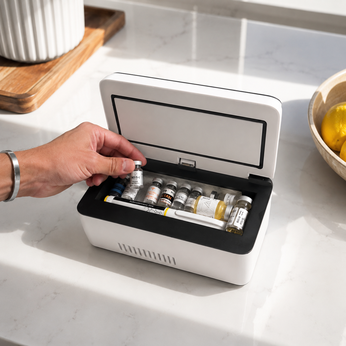 VYALOR portable peptide cooler being loaded with organized vials and a pen